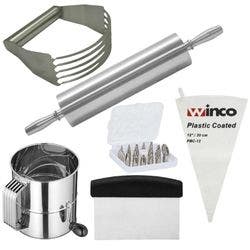 A metal dough cutter, a shiny metal rolling pin, a metal flour sifter, a metal dough scrapper with a black handle, a nylon pastry bag and cake decorating sets.