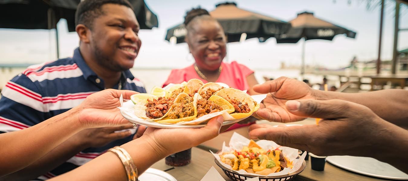 A group of African American friends shared tacos at a beach restaurant. Garifuna group from Guatemala.