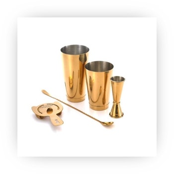 Gold finish cocktail bar set with shaker, jigger, spoon, and strainer