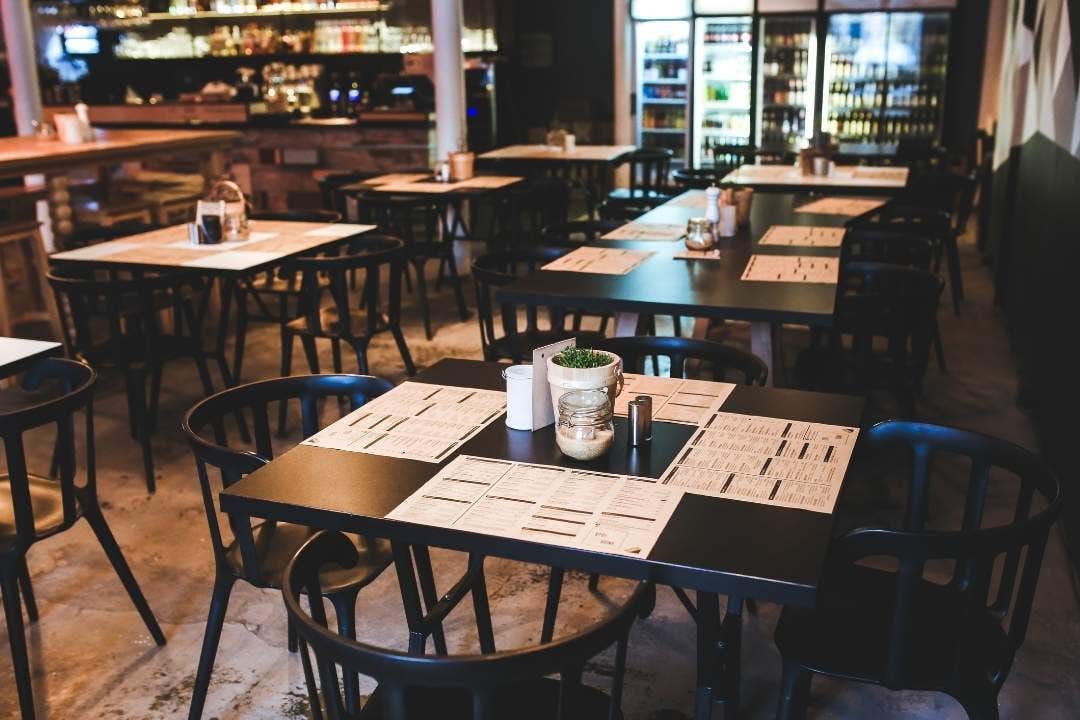 Modern restaurant dining area with black chairs and tables