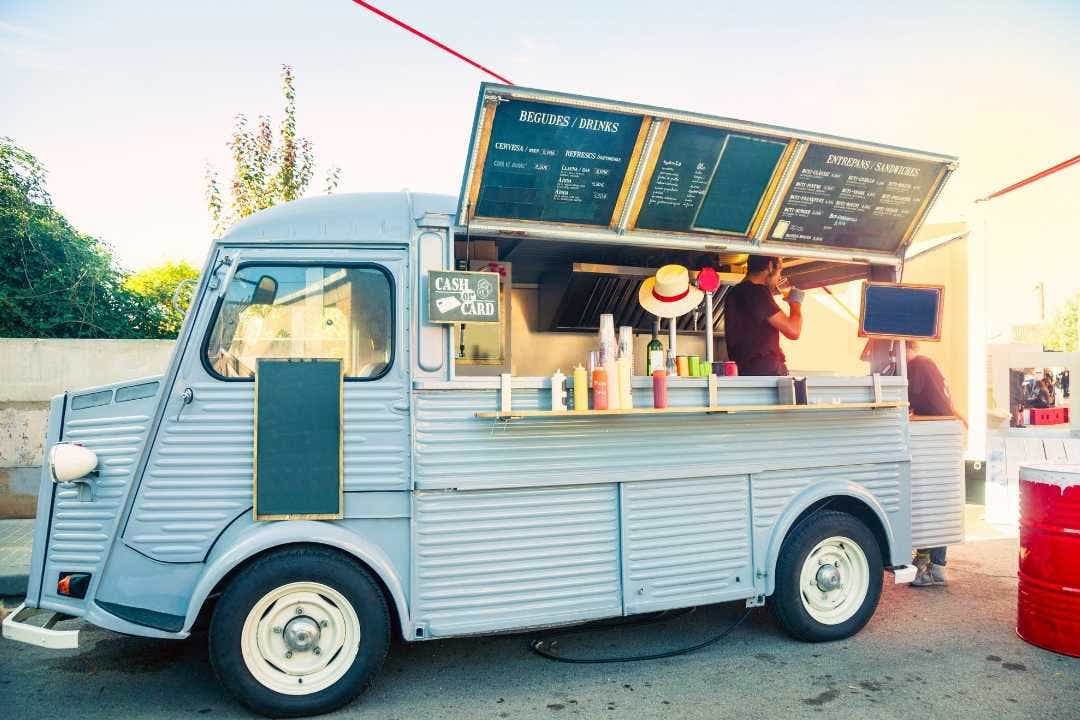 Food truck – Retro-style food truck serving drinks and sandwiches with open service window.
