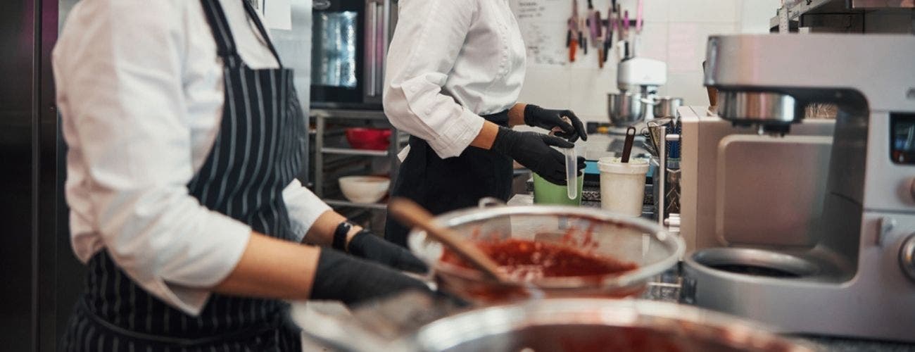 Two female chefs preparing food in the kitchen