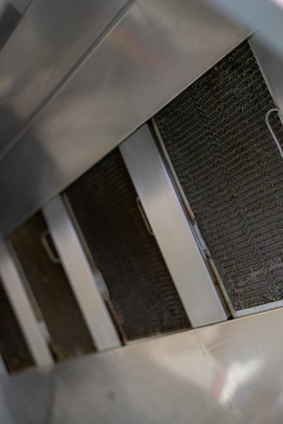 Stainless steel commercial kitchen hood ventilation system.