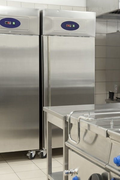 Stainless steel commercial reach in refrigerators in a commercial kitchen