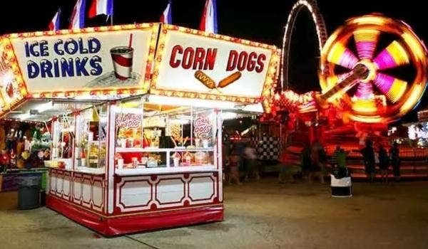 Concession stand selling drinks and corn dogs at a state fair.