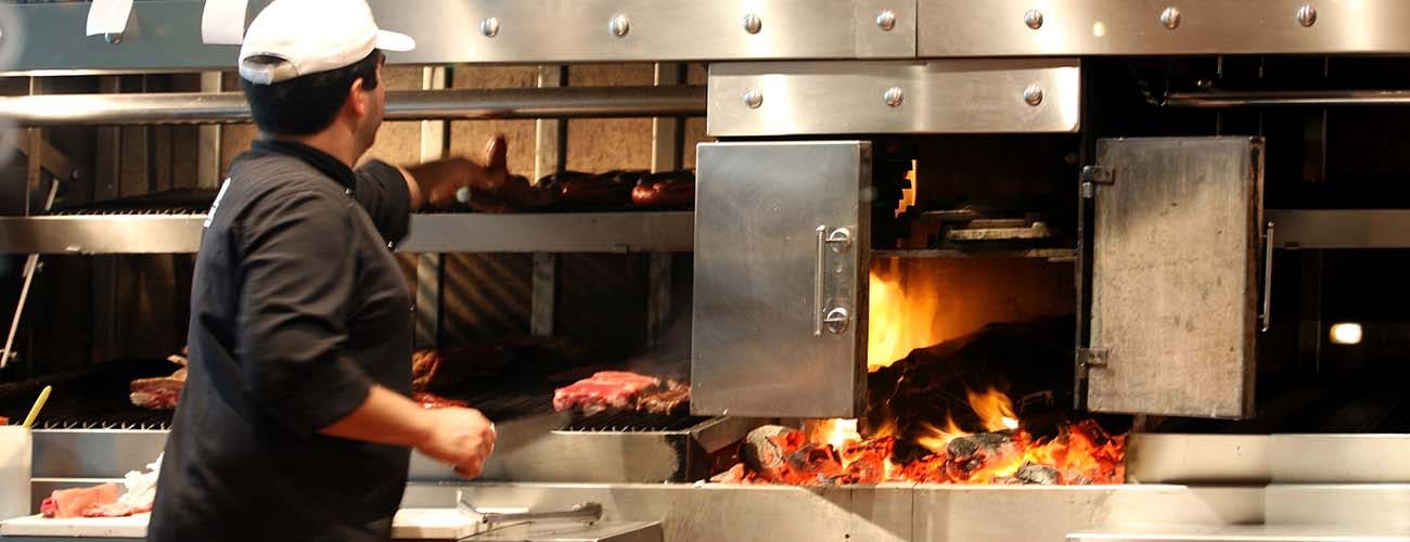 Argentinian chef cooking meat in the restaurant