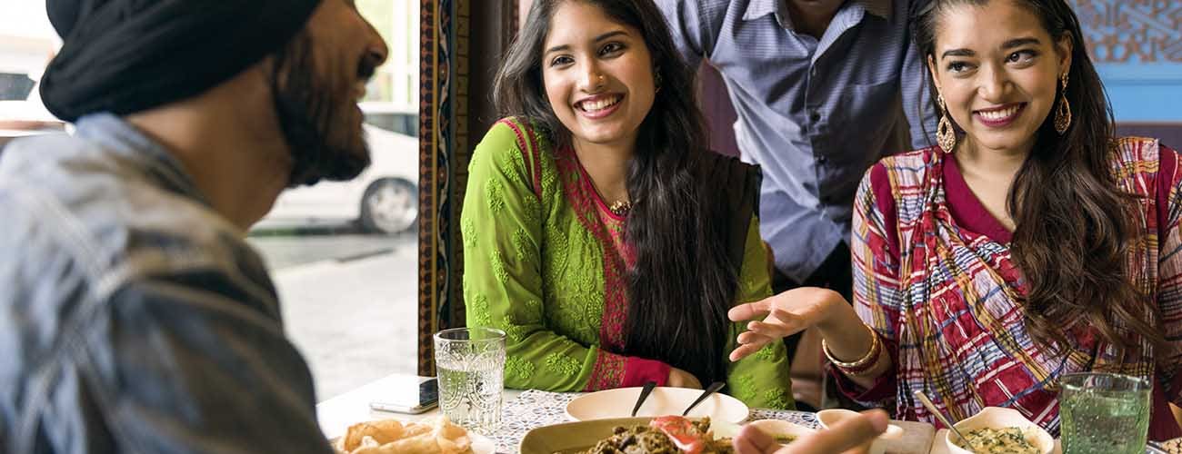 Friends eating at an Indian-style restaurant.