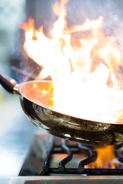 cooking food in a saute pan with a gas range