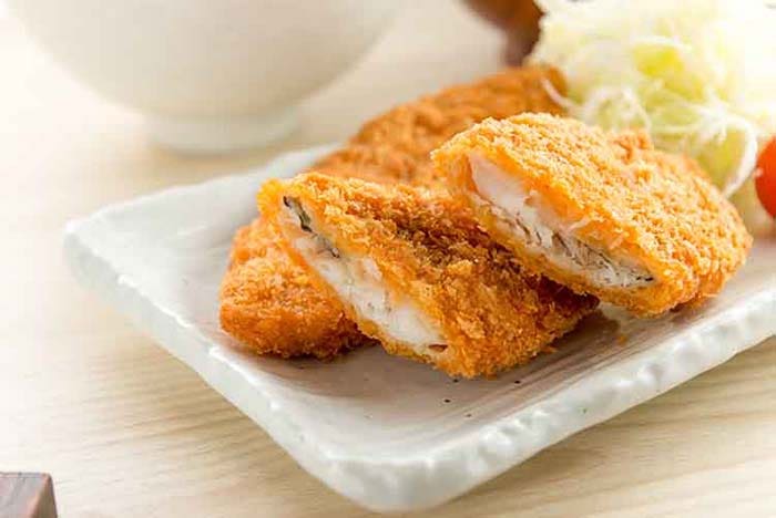 Fried fish on a white rectangular plate.