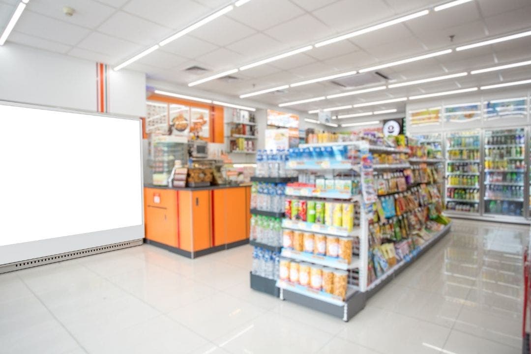 Well-stocked convenience store with snacks, drinks, and grab-and-go food displays.