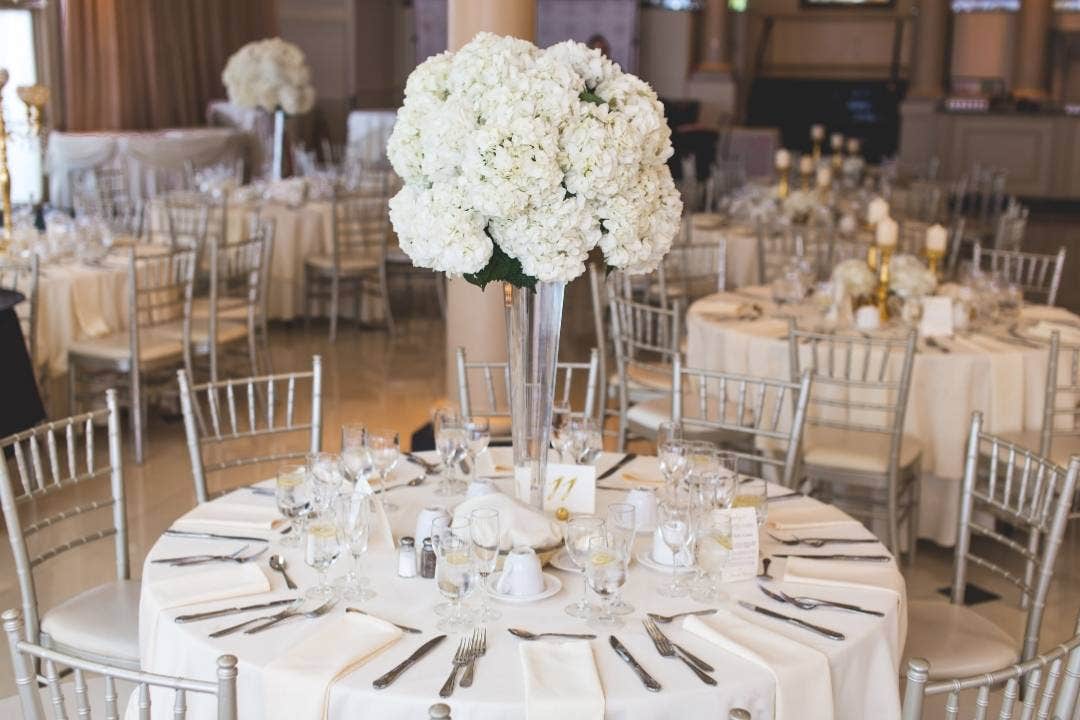 Elegant banquet hall with round tables set for a formal catering event
